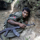 A Cambodian soldier crouches in a trench during fighting near the disputed Preah Vihear temple on Oct. 15, 2008.